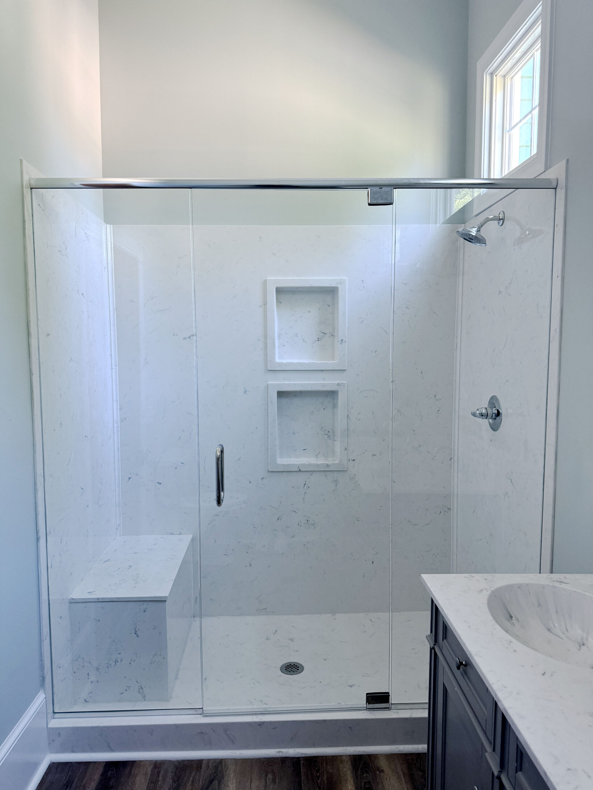Custom shower with bench seat and white tile
