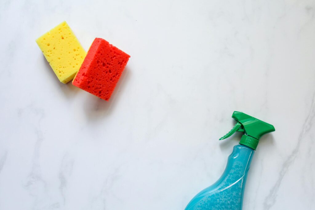 sponges and cleaner bottle on countertop